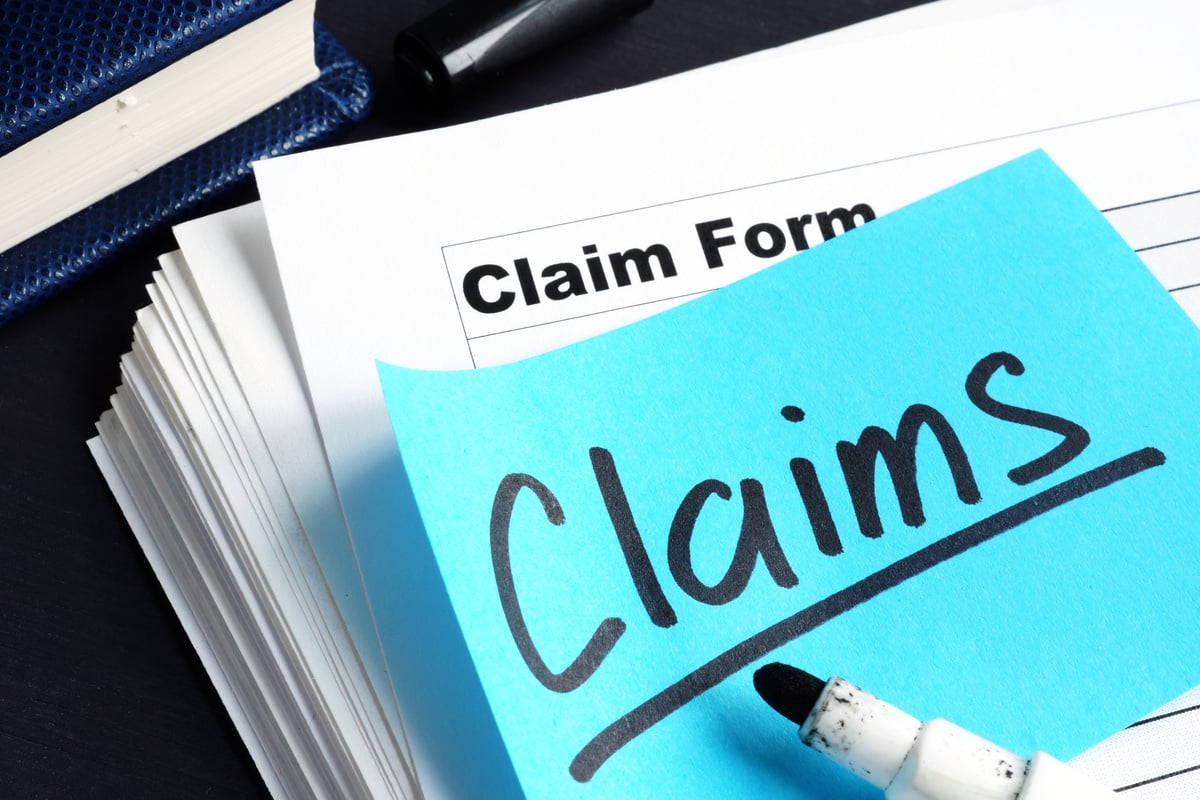 Stack of Claims applications on a desk.