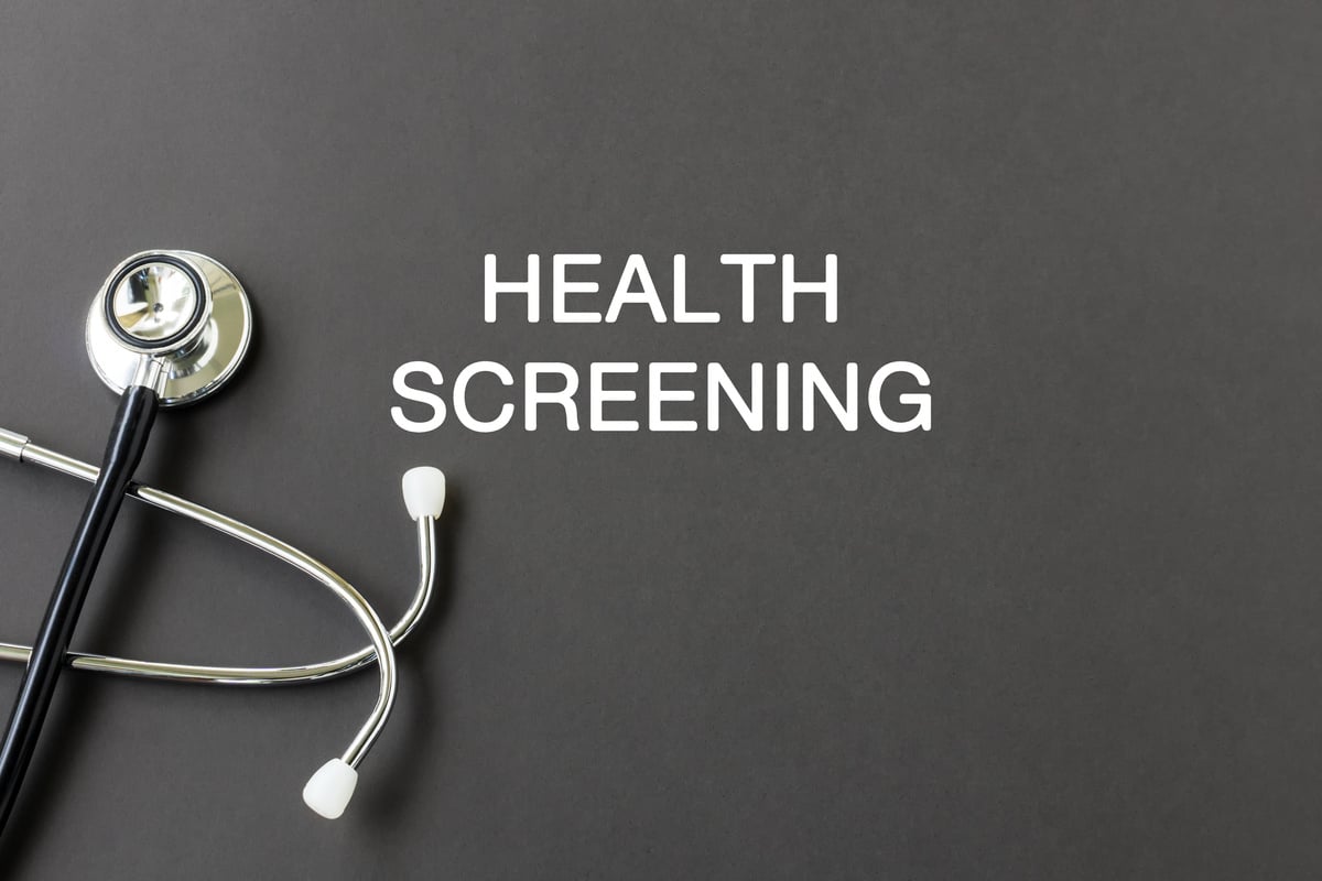 Health screening text with stethoscope